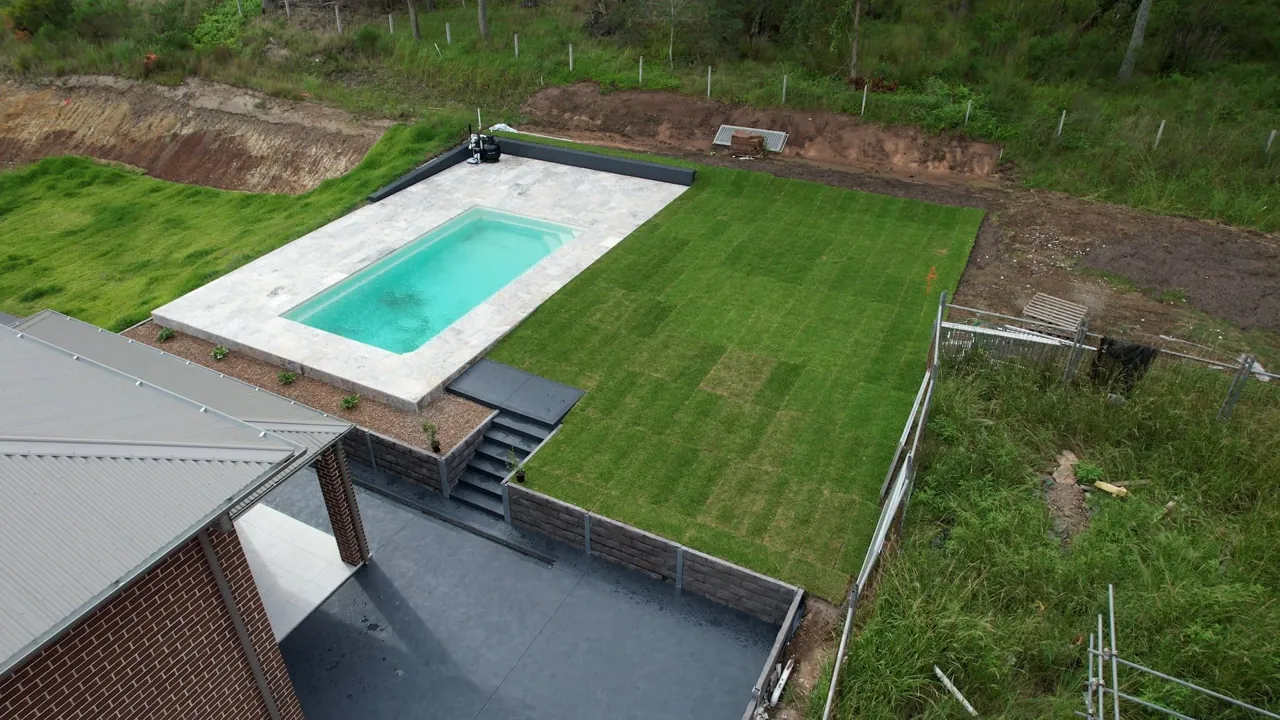 Aerial view of a completed pool surround and landscaped backyard